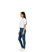 Woman wearing a white top and blue jeans on a white background