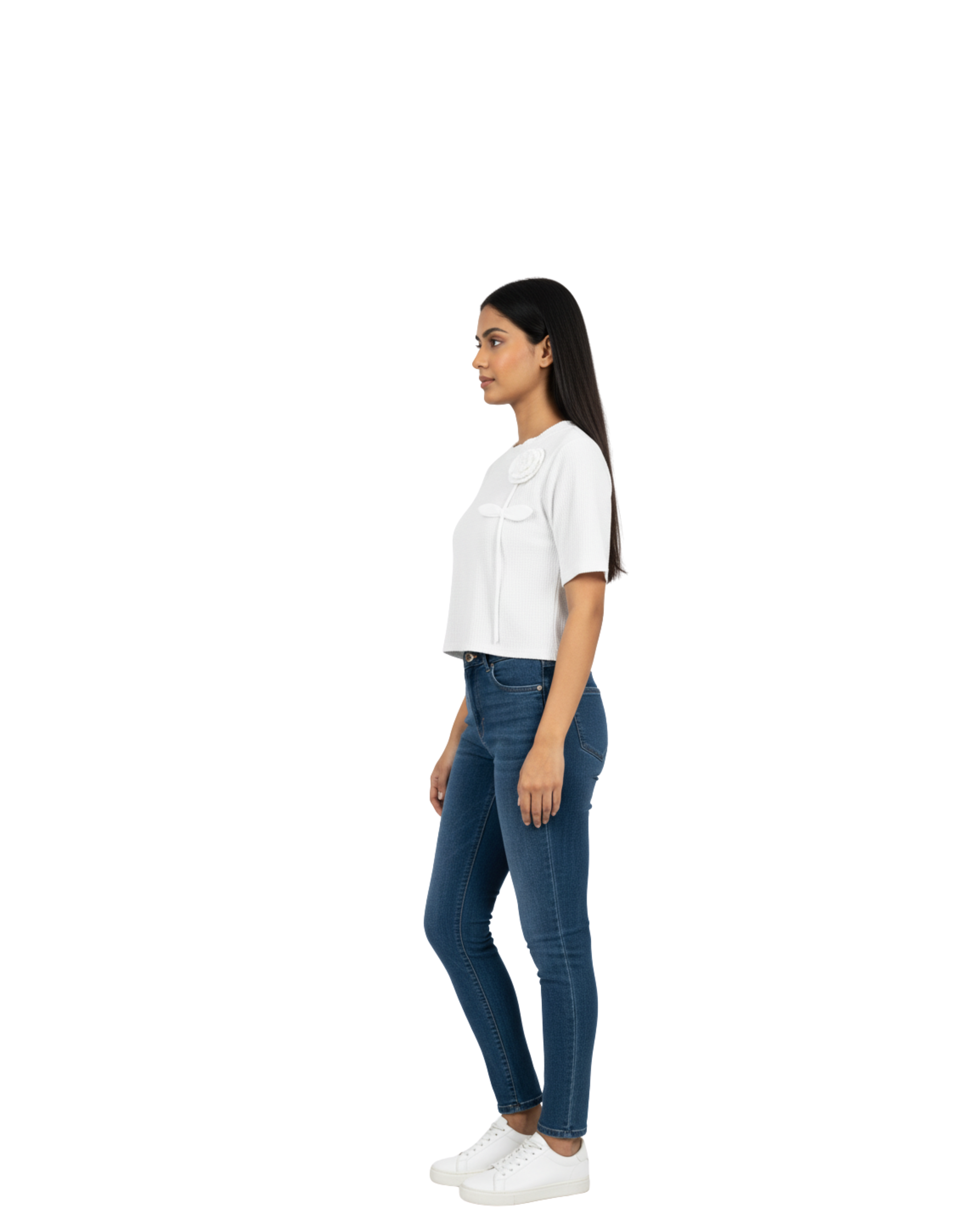 Woman wearing a white top and blue jeans on a white background