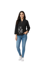 woman wearing black applique design top with white embroidery from Hava Fashions