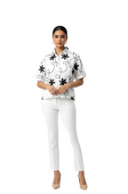 woman wearing white shirt with black floral embroidery from Hava Fashions
