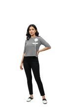 girl wearing dark grey t-shirt with white embroidered flower from Hava Fashions