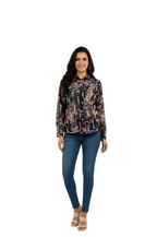 woman wearing black chiffon floral print shirt with pink and blue flowers from Hava Fashions