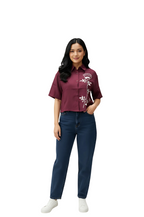 woman wearing maroon embroidered top with white floral design and collared neckline from Hava Fashions