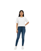 Woman wearing a white t-shirt and blue jeans on a white background