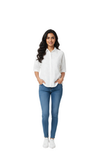 Woman wearing a white shirt and blue jeans on a white background